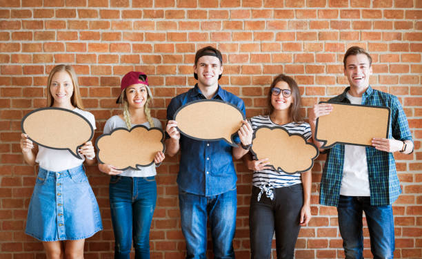 istock Happy young adults holding up copy-space placard thought bubbles 923170608