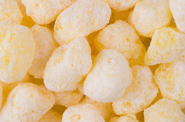 istock Sweet yellow corn sticks with powdered sugar texture, background, top view. 923174474