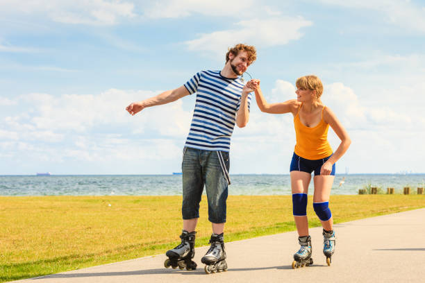 istock Youngsters together skating in seafront park. 923177858