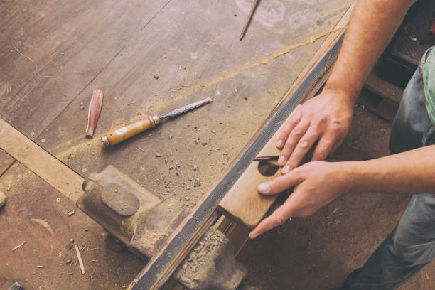 istock Carpenter working on the wood in his shop. 923180704