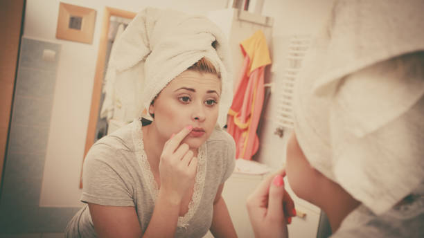 istock Woman looking at her reflection in mirror 923180782