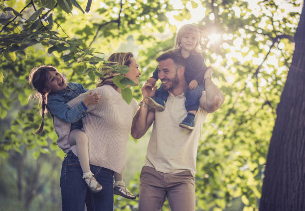 istock Playful family having fun in spring day at the park. 923185718