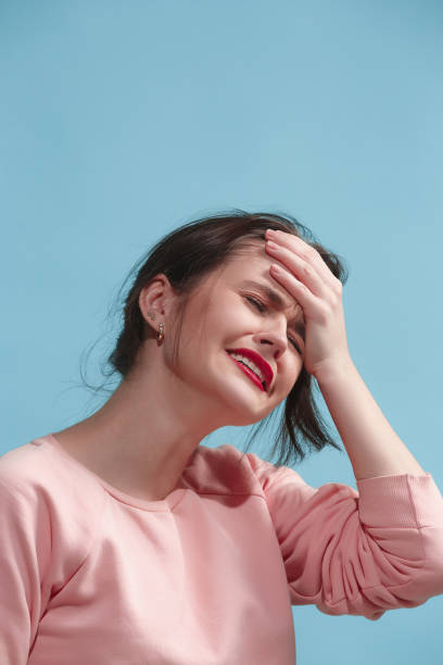 istock Woman having headache. Isolated over blue background 923186220
