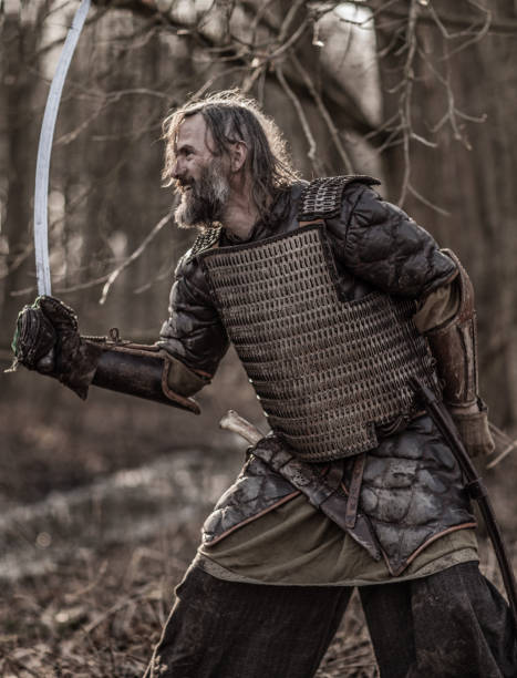 istock Weapon wielding bloody viking warrior alone in a winter forest 923186432