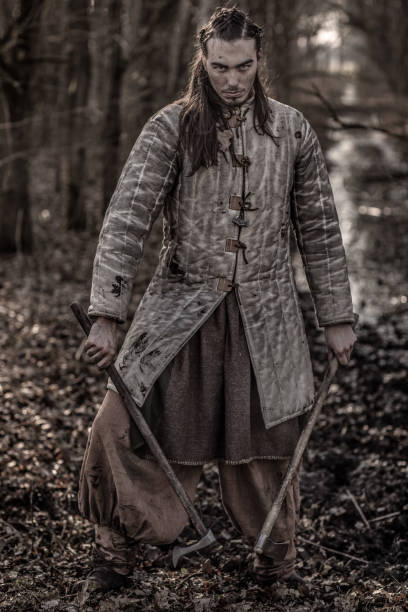istock Weapon wielding bloody viking warrior alone in a winter forest 923186618