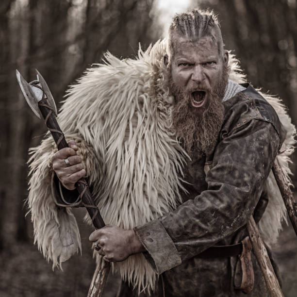 istock Weapon wielding bloody viking warrior alone in a winter forest 923186664
