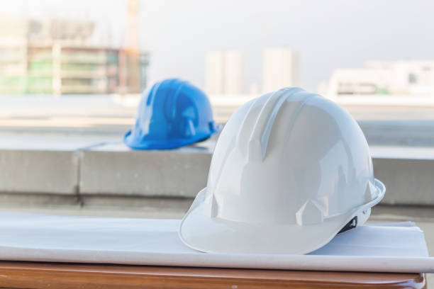 istock The white safety helmet at construction site with crane background 923188922