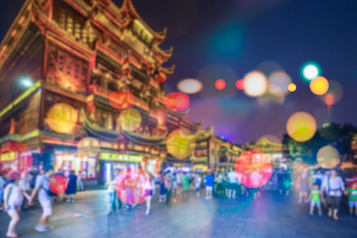 Abstract blurred people socializing during shanghai yuyuan garden at night