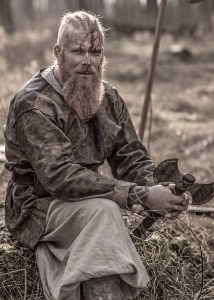 istock Weapon wielding bloody viking warrior alone in a winter forest 923189016