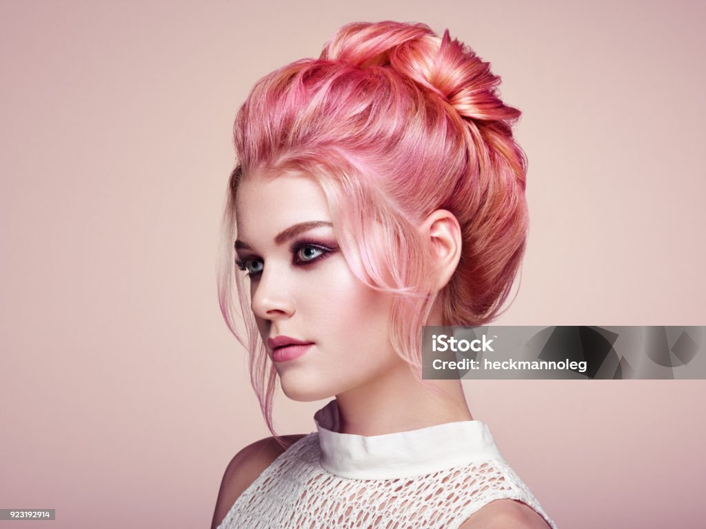 Blonde girl with elegant and shiny hairstyle Blonde Girl with Elegant and shiny Hairstyle. Beautiful Model Woman with Curly Hairstyle. Care and Beauty Hair products. Perfect Make-Up Hair Stock Photo