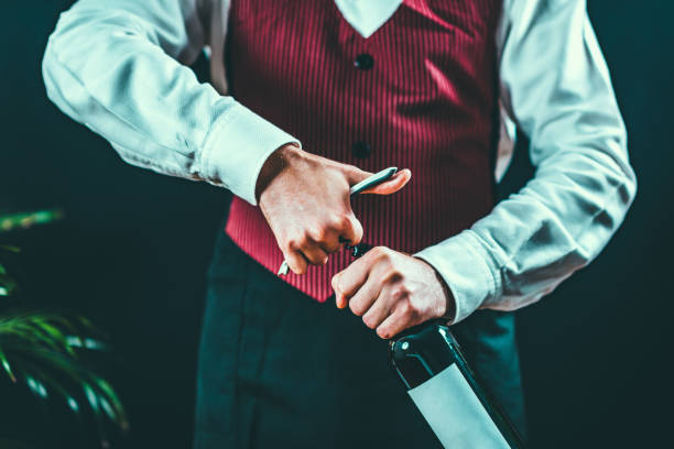 istock Midsection Of Waiter Holding Wine Bottle 923205772