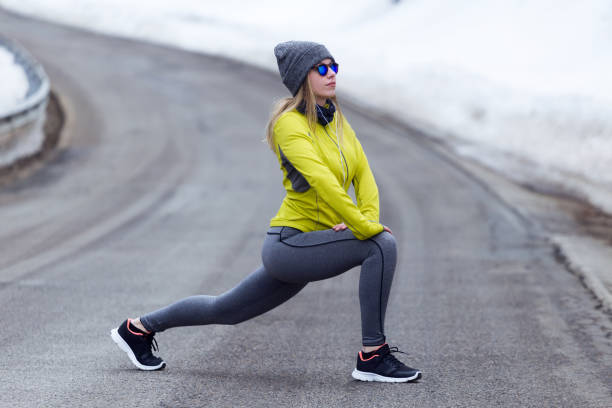 istock Young woman stretching and preparing for running on the road. 923205974