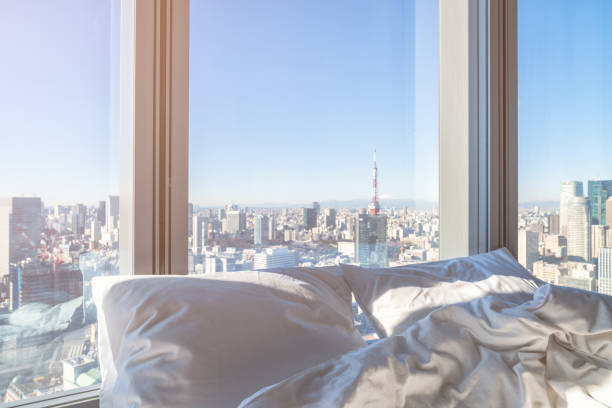 istock Morning sunshine on the bed with cityscape 923206494