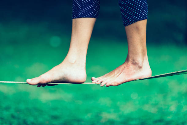 istock Low Section Of Person Walking On Tightrope 923206550