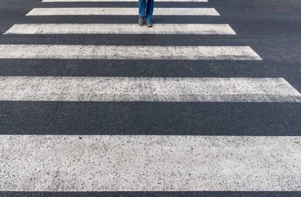 istock Low Section Of Person Walking On Zebra Crossing 923207228