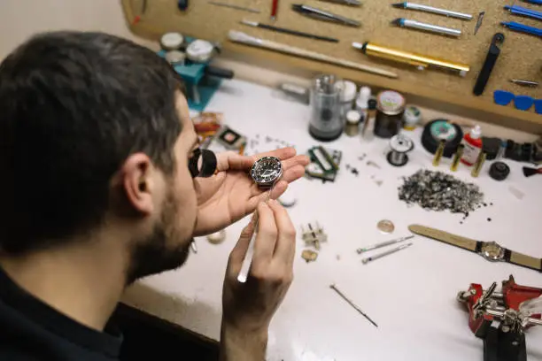 Close up of watchmaker repair mechanical watch.