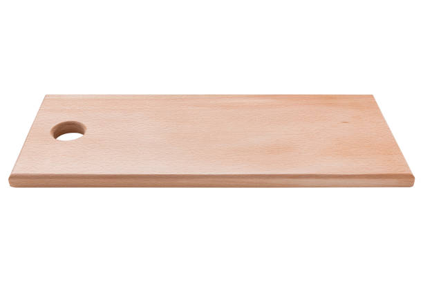 istock wooden cutting board on white background, side view 923212416
