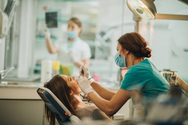 istock Young woman having her teeth checked during appointment at dentist's office. 923215902