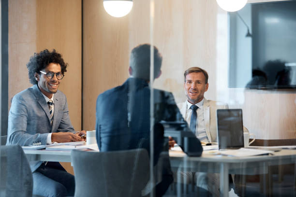istock Smiling male colleagues discussing in board room 923221834