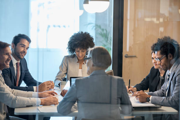 istock Coworkers sitting in board room during meeting 923222100