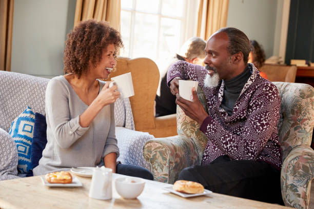 istock Middle Aged Couple Sitting Around Table In Coffee Shop 923222294
