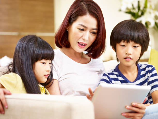 istock asian mother using digital tablet with son and daughter 923224994