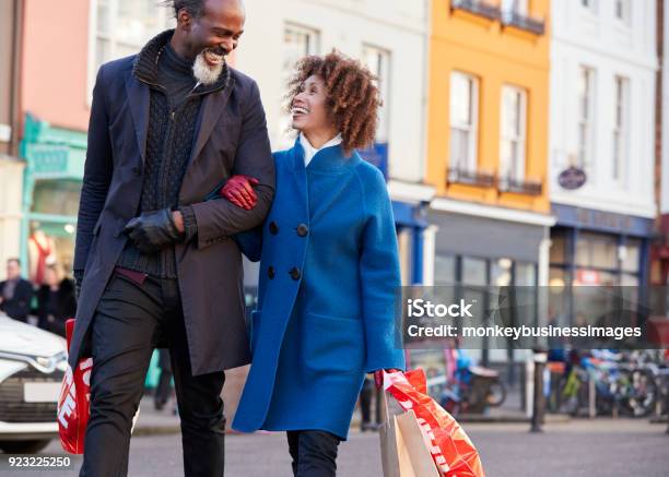 Mature Couple Enjoying Shopping In City Together Stock Photo - Download Image Now - Shopping, Retail, Mature Couple