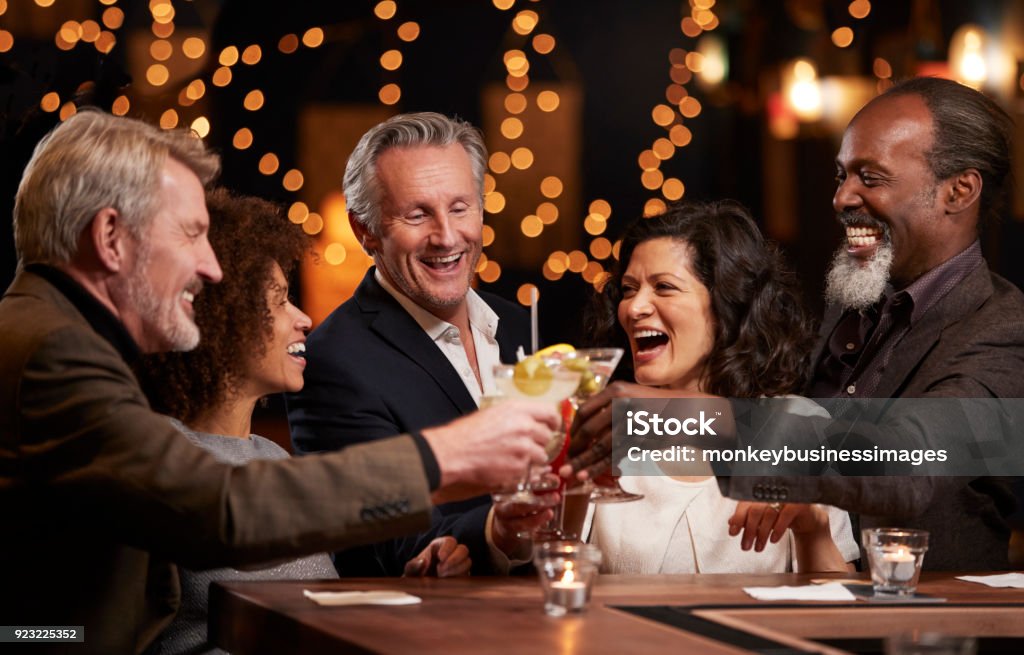 Group Of Middle Aged Friends Celebrating In Bar Together Party - Social Event Stock Photo