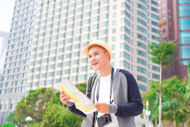 istock Young Asian traveling backpacker having fun in the city 923225742