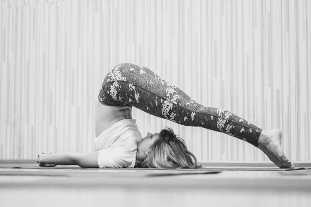 istock girl doing yoga in the hall 923228358