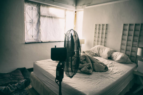 istock Electric fan in-front of an unmade bed 923228366