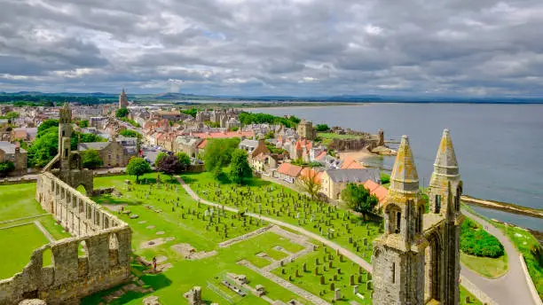 The town of St Andrews seen from the St Rule's tower. You can see the ruins of the Cathedral, built in 1158, and the ruins of the Castle, dating to the 1200s. St Andrews, Fife, Scotland.