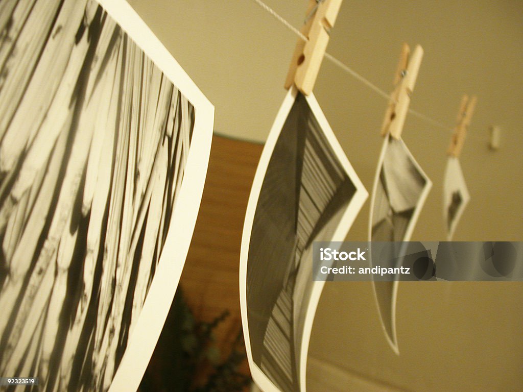 photos hanging to dry  Darkroom Stock Photo
