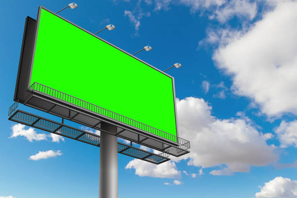 istock empty billboard with chroma key green screen, on blue sky with clouds, advertisement 923244392