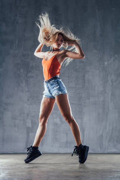 istock Young beautiful female dancer is posing in the studio 923245234