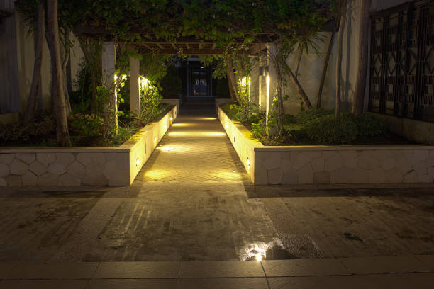 istock Romantic path at night with mood lighting in luxurious fancy district for dining and night life. 923245236