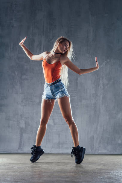 istock Young beautiful female dancer is posing in the studio 923245276