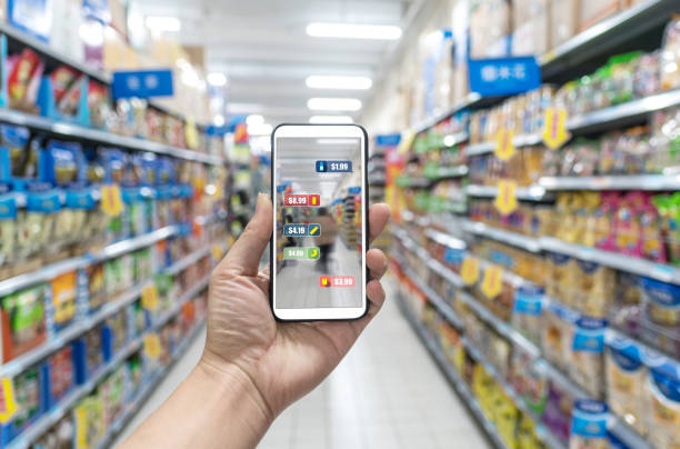 man holding the smart phone, using the Augmented Reality buy some food in the supermarket man holding the smart phone, using the Augmented Reality buy some food in the supermarket beacon photos stock pictures, royalty-free photos & images