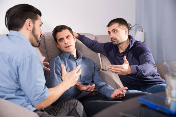 istock Two troubled men talking with friend 923246134