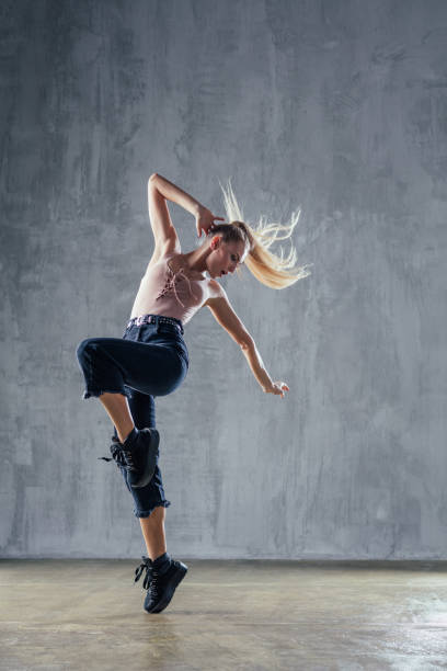 istock Young beautiful female dancer is posing in the studio 923252516