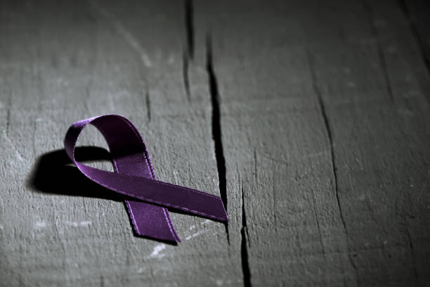 purple ribbon against the violence against women stock photo