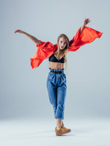 istock Young beautiful female dancer is posing in the studio 923255684