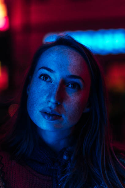 istock Girl illuminated by neon lights 923259094