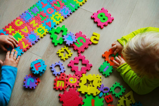 istock kids playing with numbers and letters puzzle, education concept 923262206