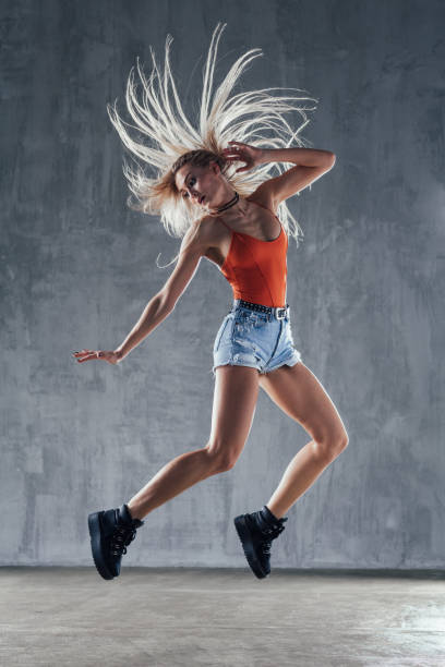 istock Young beautiful female dancer is posing in the studio 923262408
