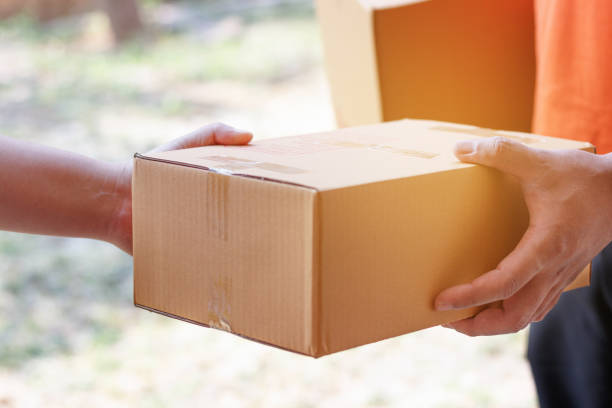 istock Customer signing document and receiving the parcel from delivery man. 923263318