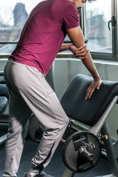istock Young men lifting weights in gym 923263710