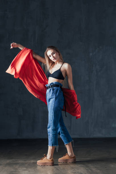 istock Young beautiful female dancer is posing in the studio 923273948