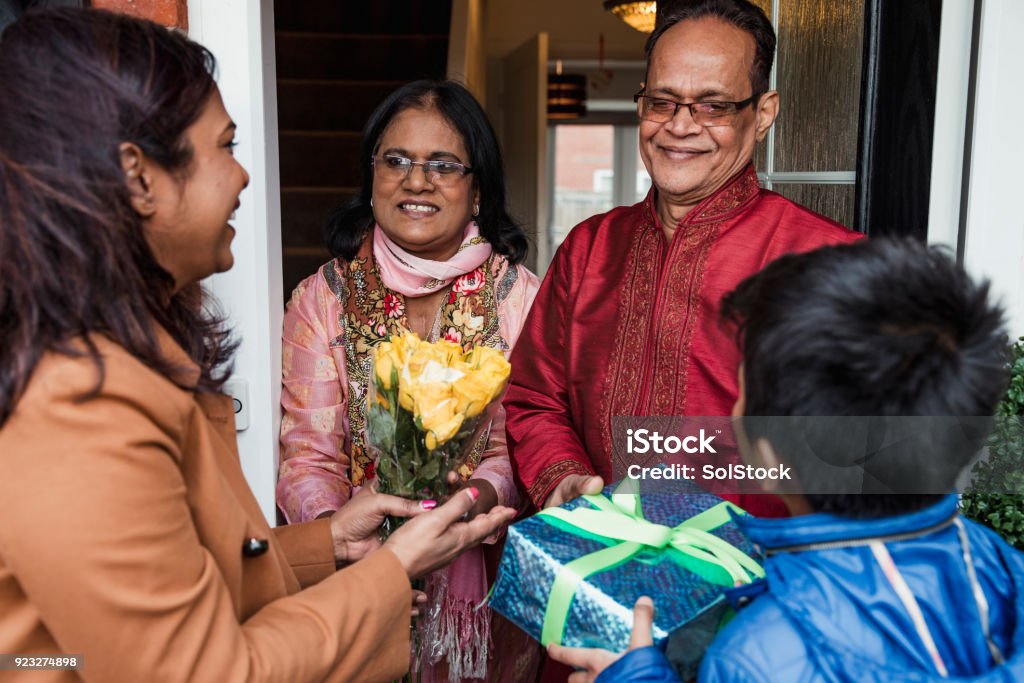 Greeting Family with Gifts A family greet one another with gifts. The senior adults are wearing a kurta/salwar kameez. The senior woman is also wearing a duppatta. Bangladesh Stock Photo Greeting Family with Gifts A family greet one another with gifts. The senior adults are wearing a kurta/salwar kameez. The senior woman is also wearing a duppatta. Bangladesh Stock Photo