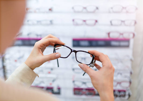 istock Woman choosing glasses in optician store 923279556
